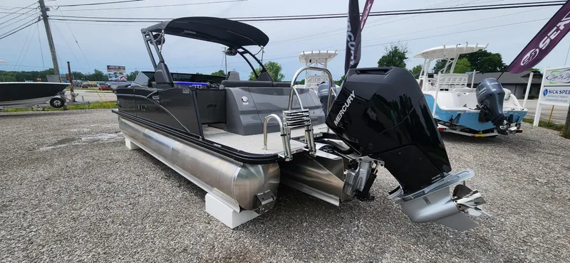 Slide: The Image of 2024 Avalon Windshield Catalina 2585 pontoon boat with outboard motor, displayed on gravel lot. - 5
