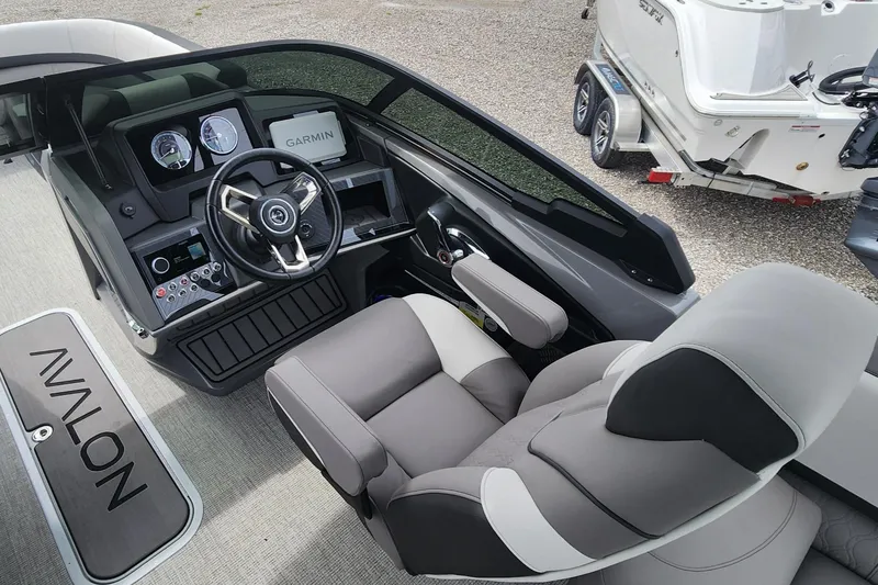 Slide: The Image of 2024 Avalon Windshield Catalina 2585 boat cockpit with steering wheel and Garmin display. - 8