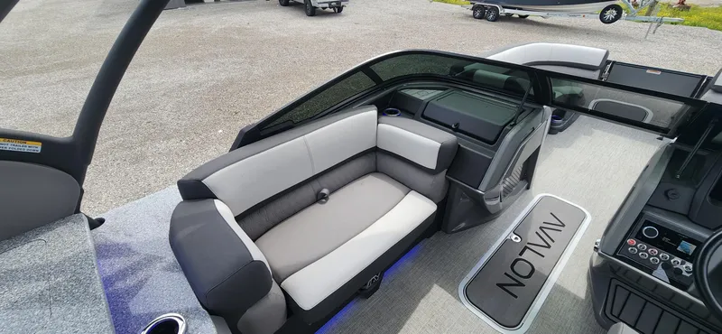 Slide: The Image of 2024 Avalon Windshield Catalina 2585 boat interior with gray seating and modern dashboard. - 9
