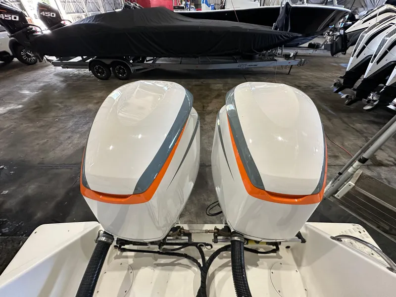 Slide: The Image of Twin outboard motors on a 2003 Intrepid 322 Cuddy boat in a storage facility. - 11