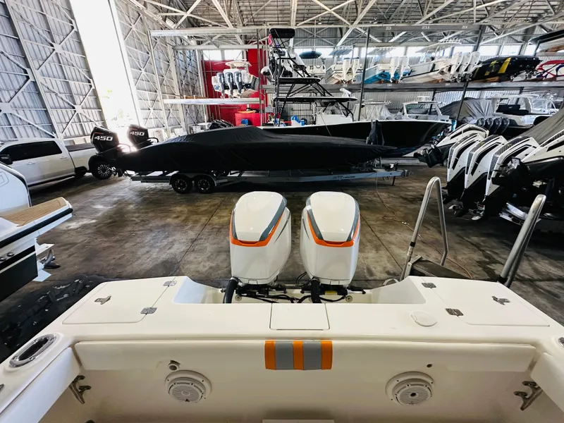 Slide: The Image of 2003 Intrepid 322 Cuddy boat in storage with dual outboard engines. - 12