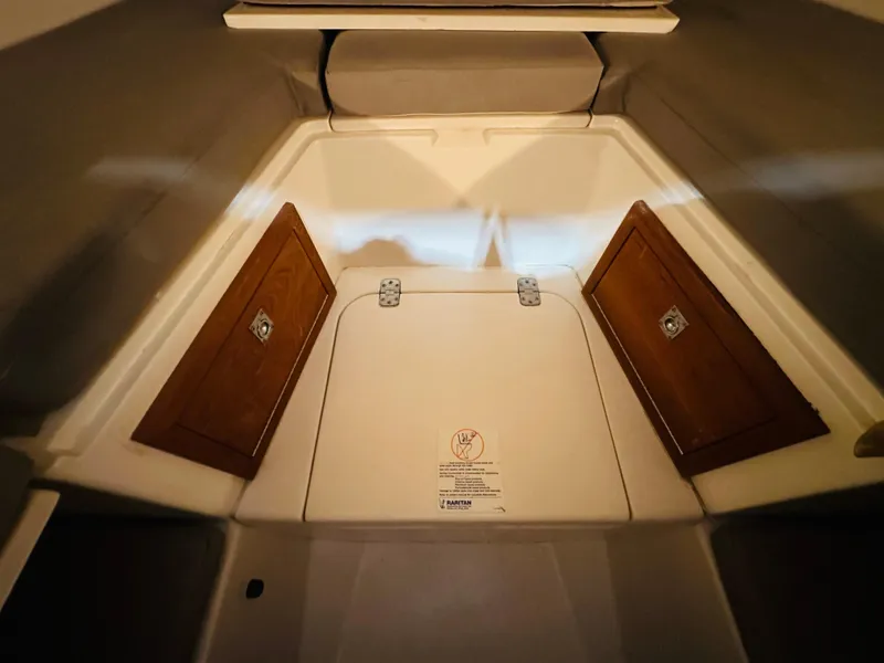 Slide: The Image of 2003 Intrepid 322 Cuddy cabin interior with wooden storage compartments. - 3