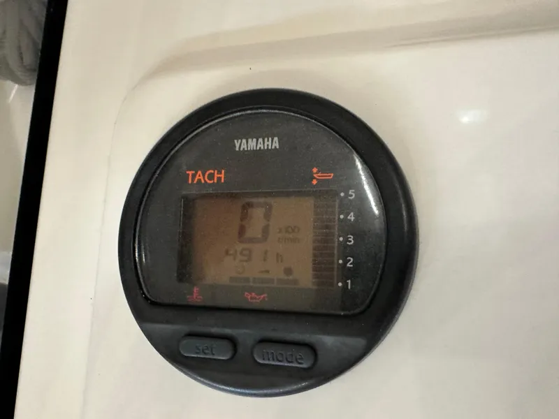 Slide: The Image of Yamaha tachometer on 2003 Intrepid 322 Cuddy boat dashboard, displaying 491 hours. - 4