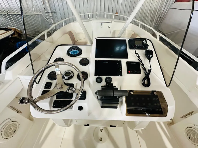 Slide: The Image of 2003 Intrepid 322 Cuddy helm with steering wheel, gauges, and navigation equipment. - 8