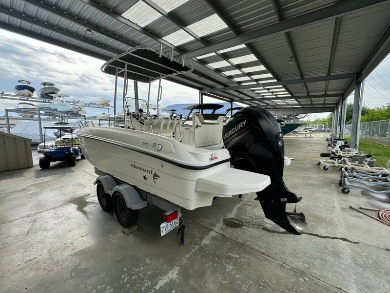 Slide: The Image of 2017 Bayliner Element F21 boat with Mercury outboard motor in covered storage. - 2