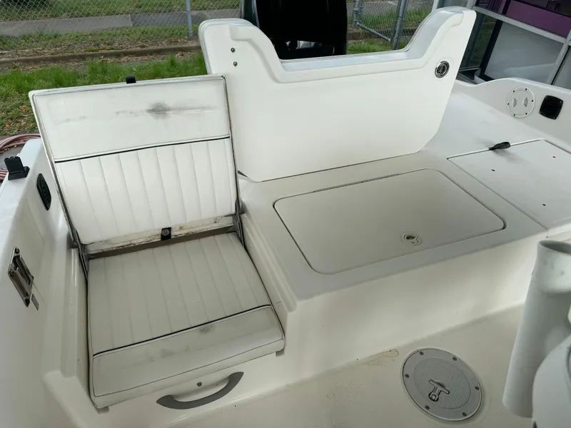 Slide: The Image of 2017 Bayliner Element F21 boat interior with white seating and storage compartments. - 5