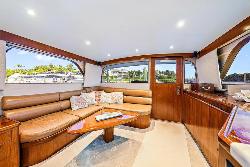 Slide: The Image of Luxurious interior of a 1990 Monterey Custom Sportfish yacht with leather seating and wooden accents. - 12