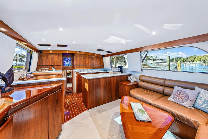 Slide: The Image of Luxurious interior of a 1990 Monterey Custom Sportfish yacht with wooden finishes and large windows. - 13