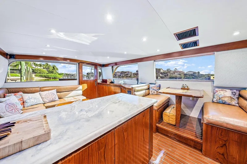 Slide: The Image of Luxurious interior of 1990 Monterey Custom Sportfish yacht with marble countertops and plush seating. - 14