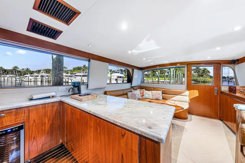 Slide: The Image of Luxurious interior of a 1990 Monterey Custom Sportfish yacht with modern kitchen and cozy seating area. - 16