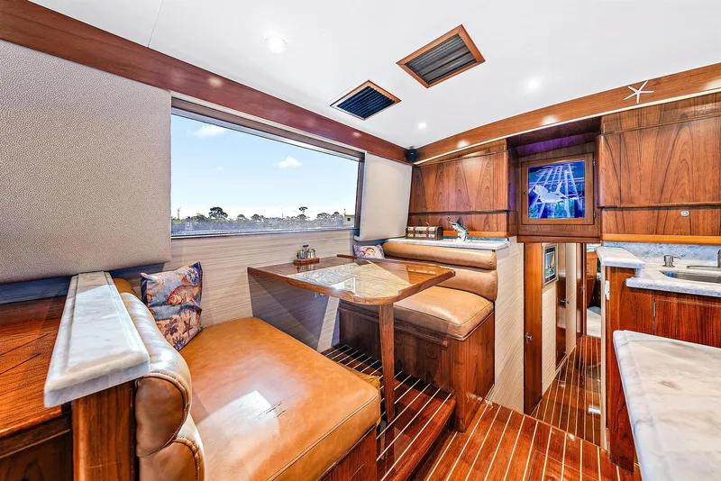 Slide: The Image of 1990 Monterey Custom Sportfish yacht interior with wood finishes and leather seating. - 17