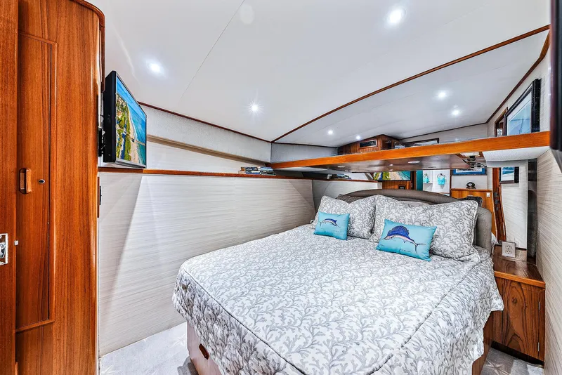 Slide: The Image of Luxurious bedroom in a 1990 Monterey Custom Sportfish yacht with modern amenities. - 18