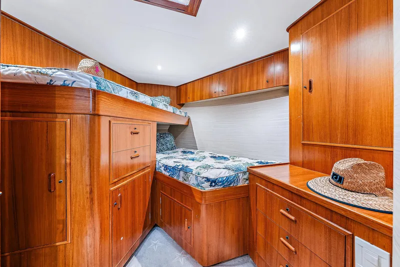 Slide: The Image of 1990 Monterey Custom Sportfish cabin with wooden cabinetry and bunk beds. - 19