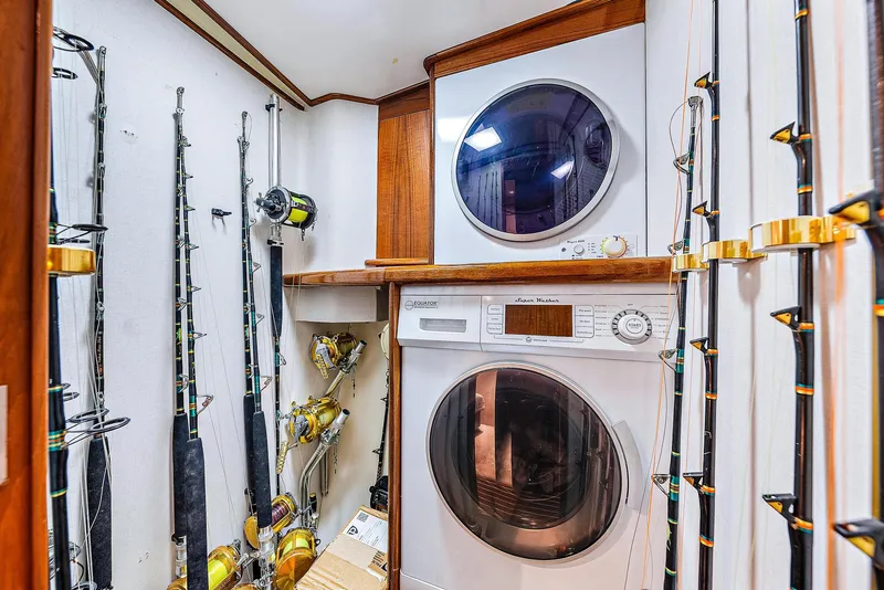 Slide: The Image of Laundry area with fishing rods on a 1990 Monterey Custom Sportfish boat. - 21