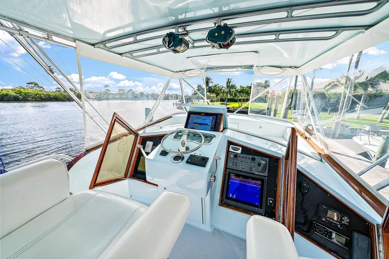Slide: The Image of 1990 Monterey Custom Sportfish boat cockpit with modern navigation equipment. - 5