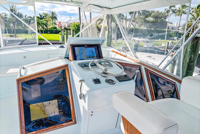 Slide: The Image of 1990 Monterey Custom Sportfish boat helm with navigation equipment and steering wheel. - 8