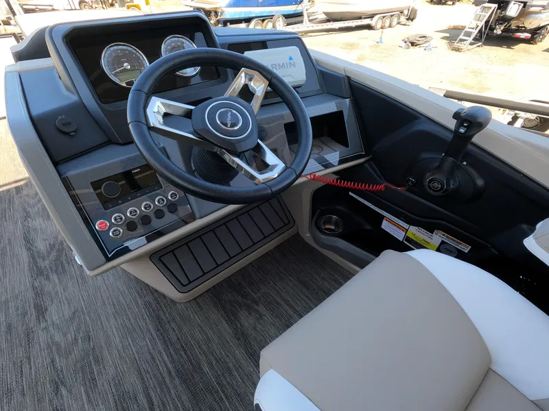 Slide: The Image of 2024 Avalon Catalina Entertainer Funship boat dashboard with steering wheel and control panel. - 6