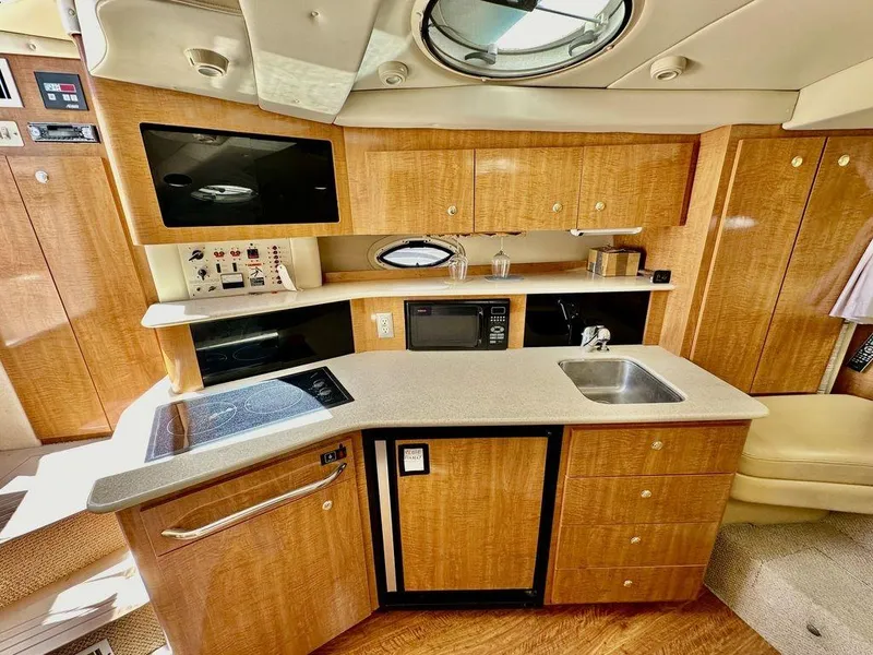 Slide: The Image of 2002 Custom 33SCR yacht kitchen with modern appliances and wooden cabinetry. - 11
