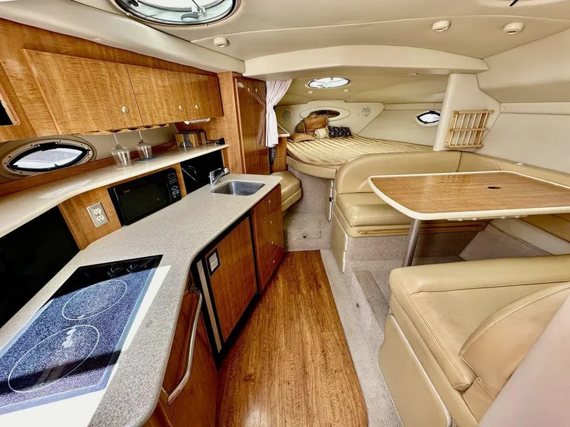 Slide: The Image of Luxurious interior of a 2002 Custom 33SCR yacht with kitchen and dining area. - 12