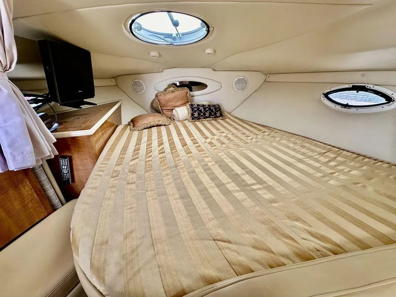 Slide: The Image of Luxurious cabin interior of 2002 Custom 33SCR boat with cozy bed and TV. - 14