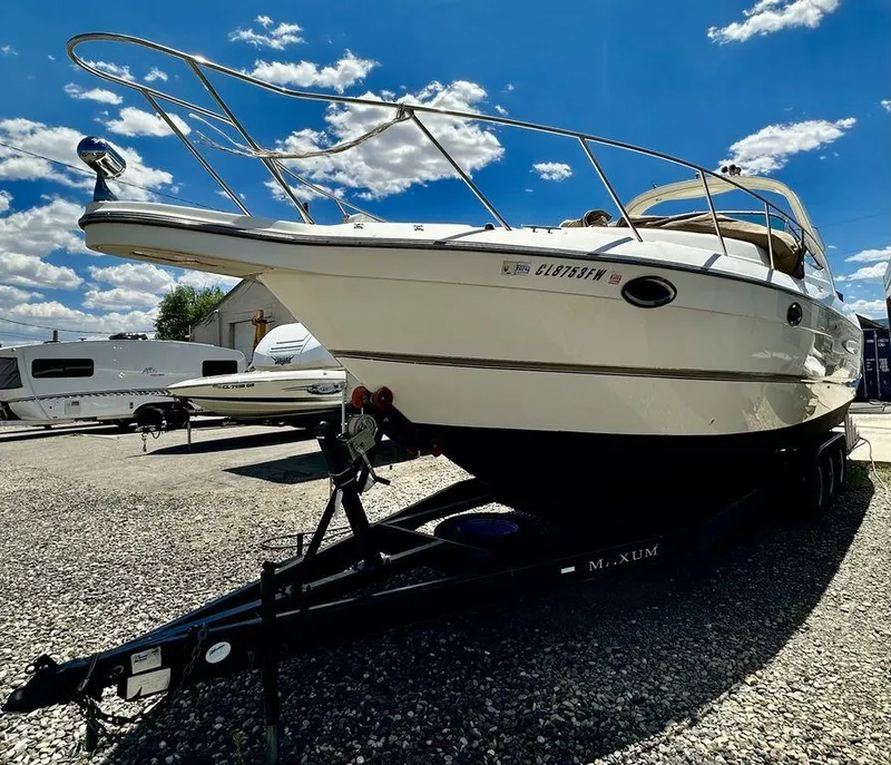 Slide: The Image of 2002 Custom 33SCR boat on Maxum trailer under a bright blue sky. - 4