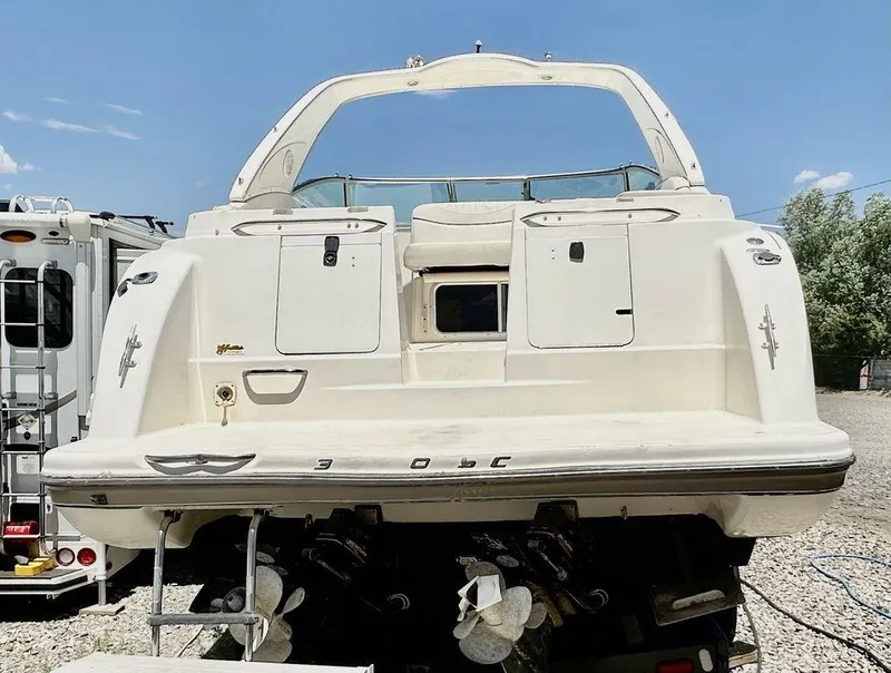 Slide: The Image of 2002 Custom 33SCR boat, rear view, white, docked on land. - 6