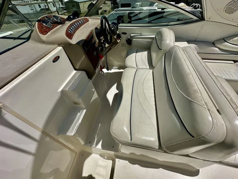 Slide: The Image of Interior of a 2002 Custom 33SCR boat with white leather seating and dashboard. - 8