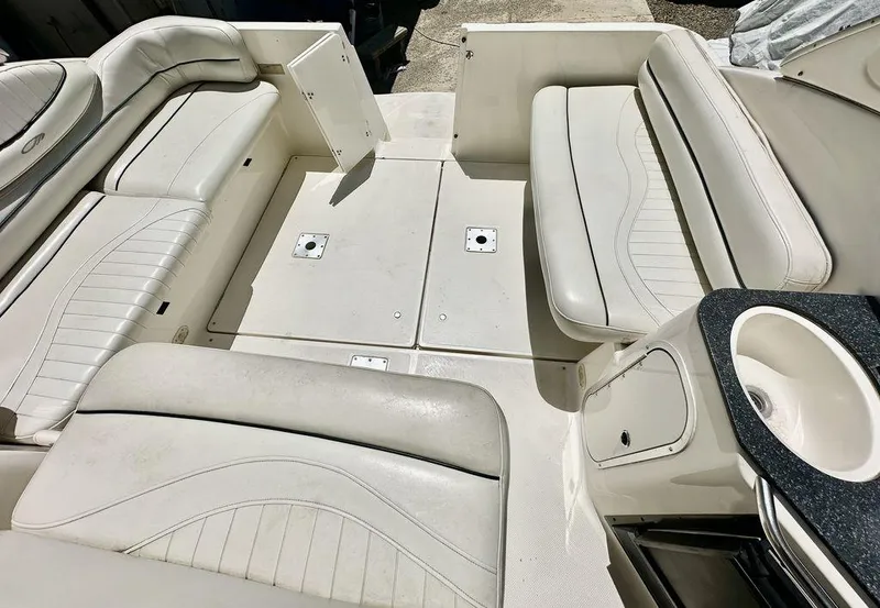 Slide: The Image of 2002 Custom 33SCR boat interior with white leather seating and built-in cup holder. - 9