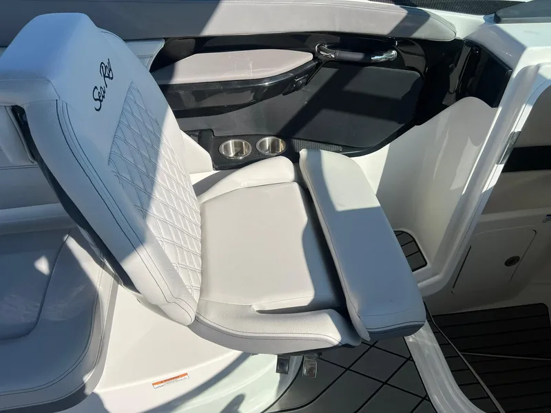 Slide: The Image of 2024 Sea Ray SLX 260 Outboard interior with white seating and cup holders. - 11