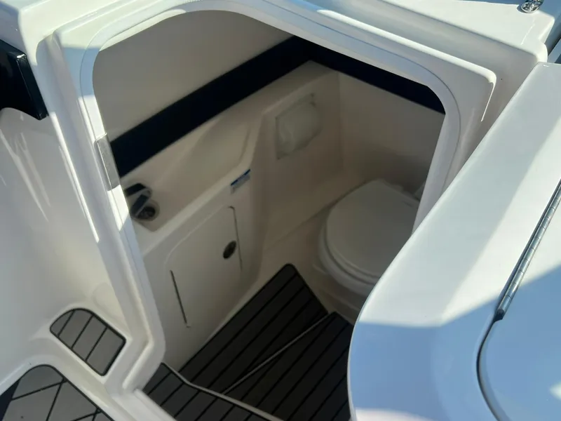 Slide: The Image of 2024 Sea Ray SLX 260 Outboard boat interior with compact bathroom. - 13