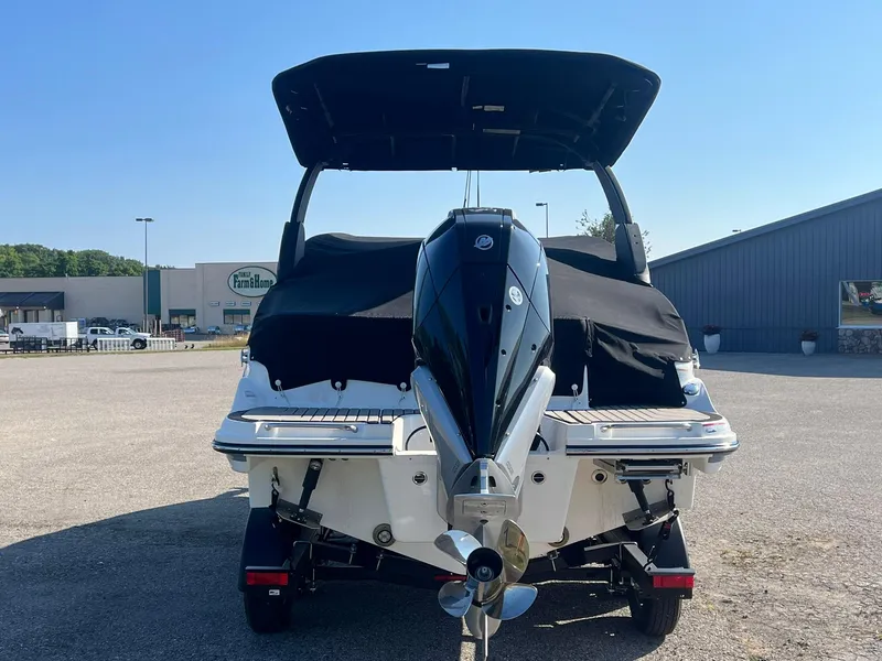Slide: The Image of 2024 Sea Ray SLX 260 Outboard boat, rear view with covered seating and outboard motor. - 2