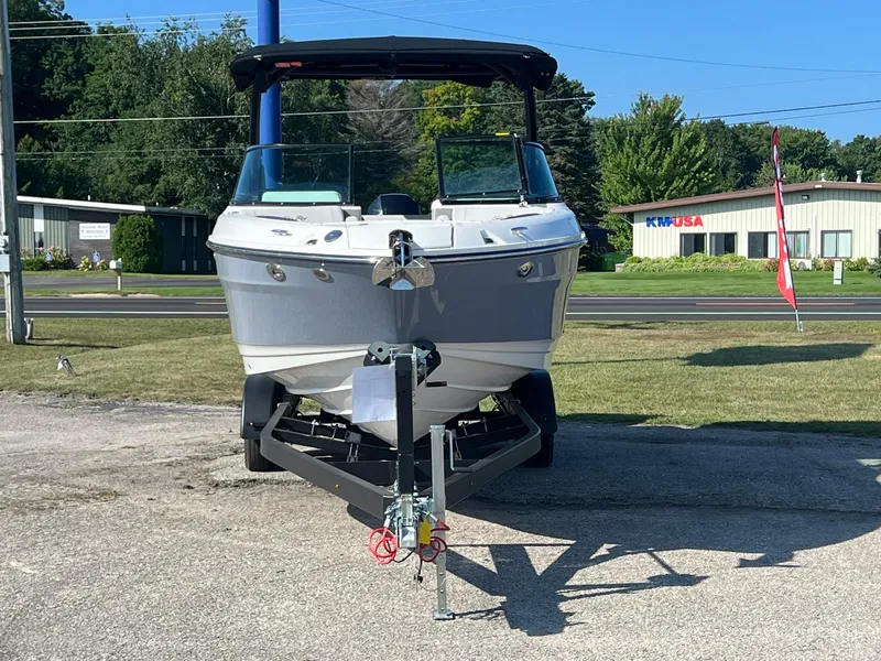 Slide: The Image of 2024 Sea Ray SLX 260 Outboard boat on trailer, parked outdoors. - 20