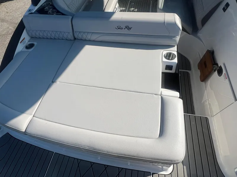 Slide: The Image of 2024 Sea Ray SLX 260 Outboard boat with luxurious white seating and sleek design. - 4