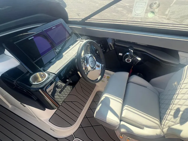 Slide: The Image of 2024 Sea Ray SLX 260 Outboard helm with modern controls and luxurious seating. - 9