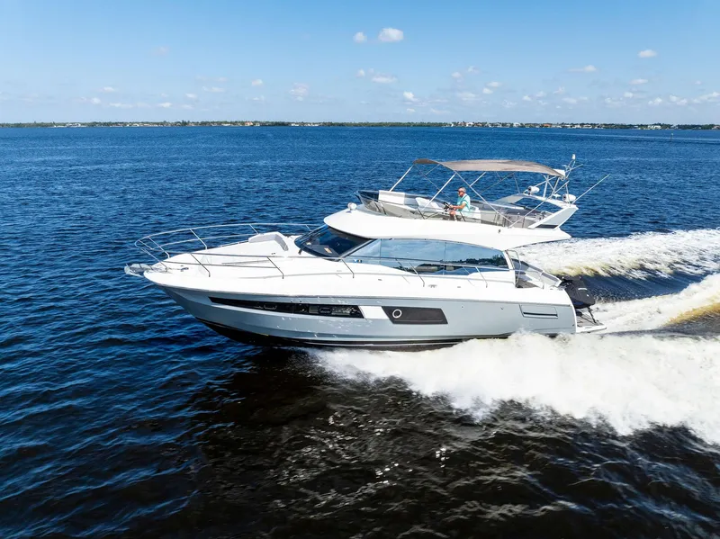 Slide: The Image of 2018 Prestige 460 yacht cruising on open water. - 10