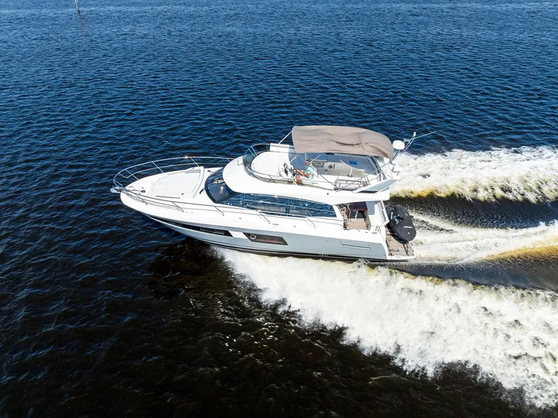 Slide: The Image of 2018 Prestige 460 yacht cruising on open water. - 11