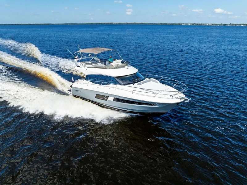 Slide: The Image of 2018 Prestige 460 yacht cruising on open water. - 13