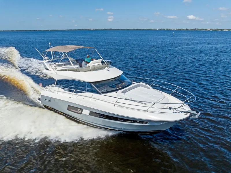 Slide: The Image of 2018 Prestige 460 yacht cruising on open water. - 14