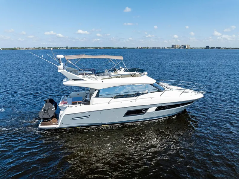 Slide: The Image of 2018 Prestige 460 yacht cruising on open water. - 15