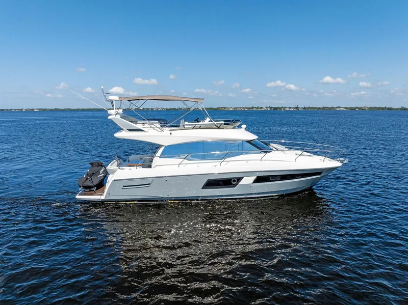 Slide: The Image of 2018 Prestige 460 yacht cruising on open water. - 17