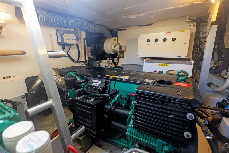 Slide: The Image of Engine room of a 2018 Prestige 460 yacht with visible machinery and components. - 23