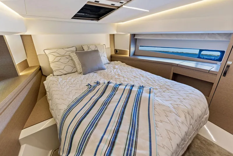Slide: The Image of Prestige 460 2018 yacht bedroom with modern decor and natural light. - 29