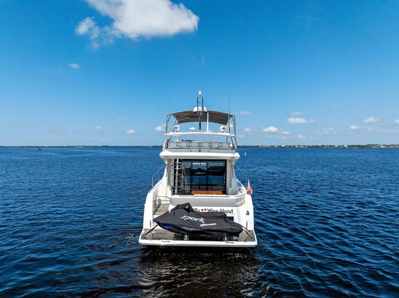 Slide: The Image of Prestige 460 yacht 2018 model on open water with jet ski on deck. - 3