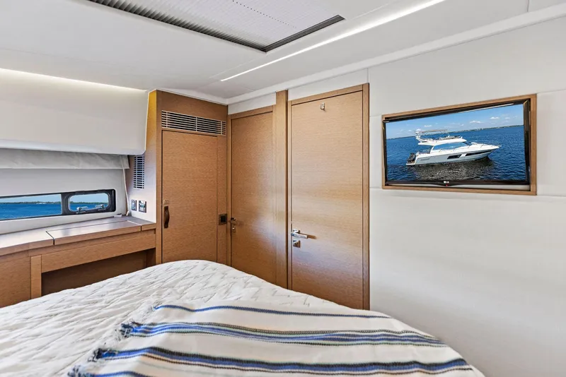 Slide: The Image of Luxurious bedroom interior of 2018 Prestige 460 yacht with TV and window view. - 31
