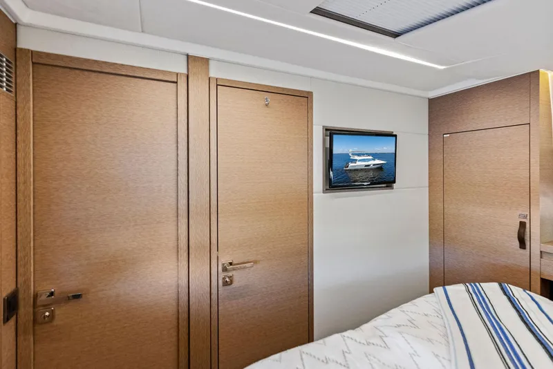 Slide: The Image of Interior of 2018 Prestige 460 yacht cabin with TV and wooden doors. - 32