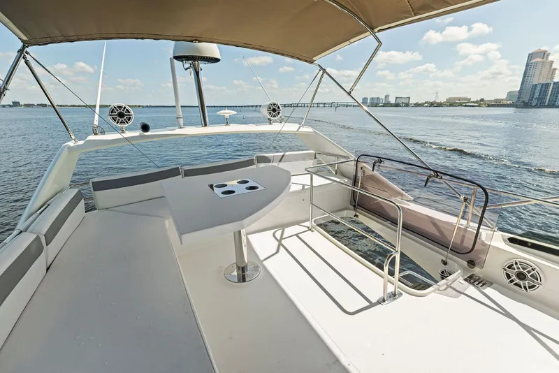 Slide: The Image of Prestige 460 yacht 2018 model, spacious deck with seating, table, and ocean view. - 46