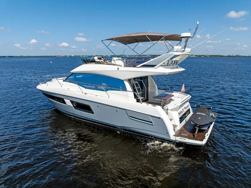 Slide: The Image of 2018 Prestige 460 yacht cruising on open water. - 5
