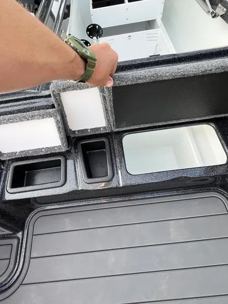 Slide: The Image of 2024 Phoenix 20 XE boat interior storage compartments and deck. - 13