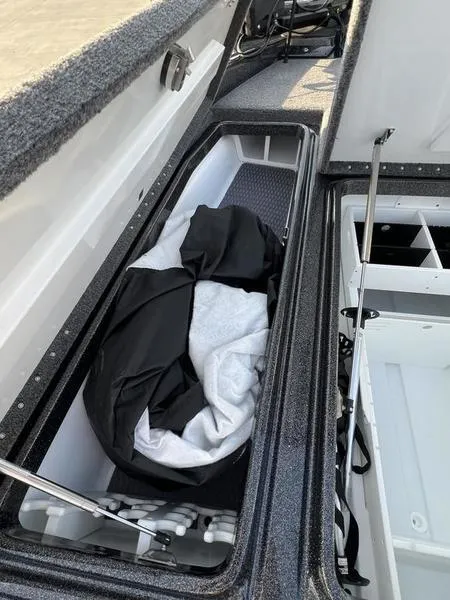 Slide: The Image of 2024 Phoenix 20 XE boat storage compartments with gear and equipment. - 15