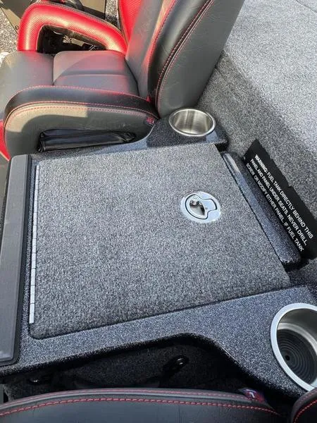 Slide: The Image of 2024 Phoenix 20 XE boat interior with storage compartment and cup holders. - 24